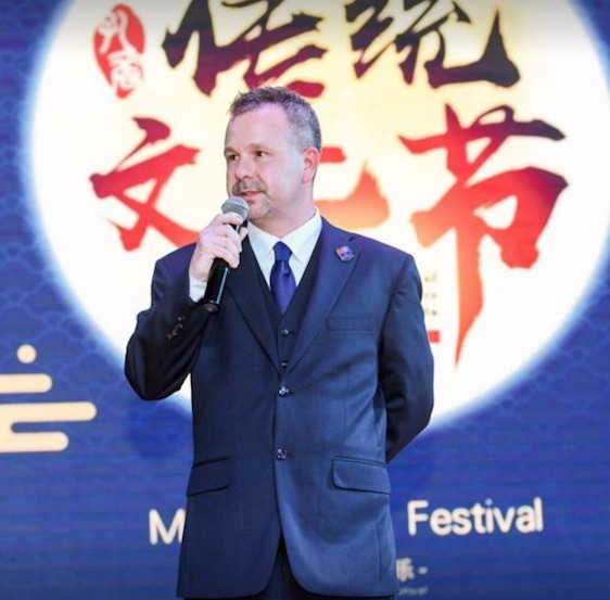 Educators and students engaged in studio critique and collaborative learning.